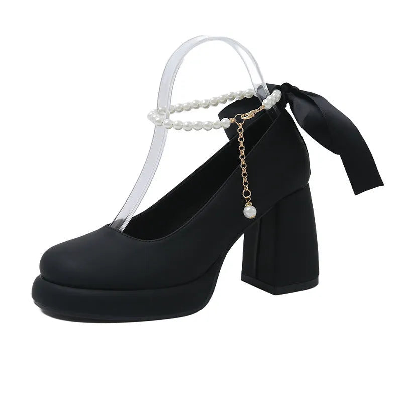 Women's beige Mary Jane shoes with chunky heel, round toe, and ankle strap with pearl buckle.