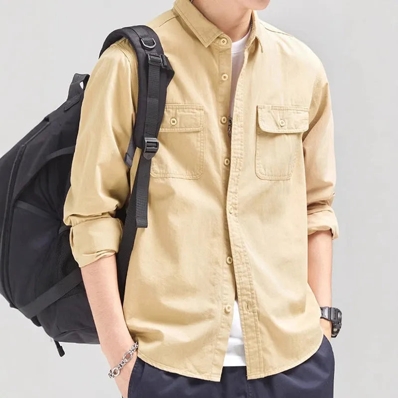 Man wearing a loose fit, long sleeve cardigan-style shirt overall in khaki polyester fabric.