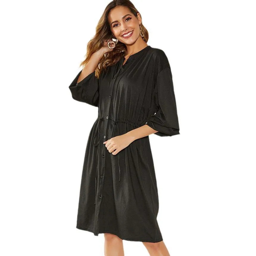 Women's black elastic waist A-line dress with cinched belt and long sleeves