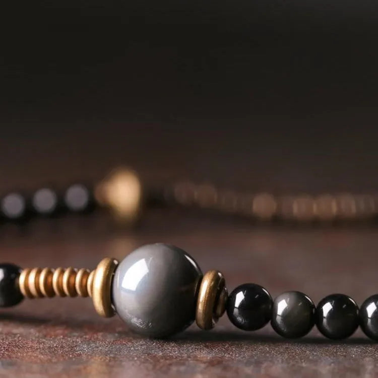 Black geometric beaded bracelet with colourful layered retro design.