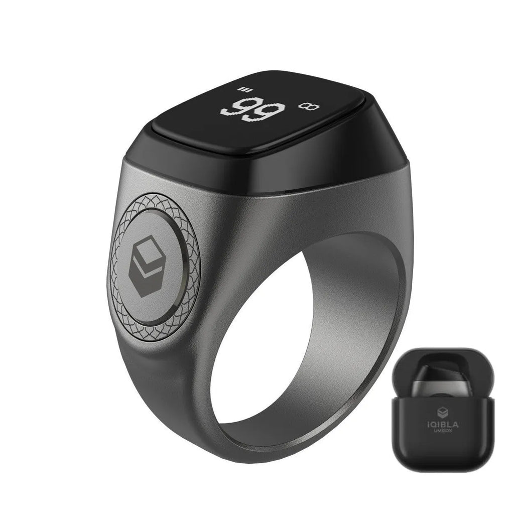 Zikr1 smart ring in black, green, rose gold, or silver on charging case with OLED display showing dhikr count.