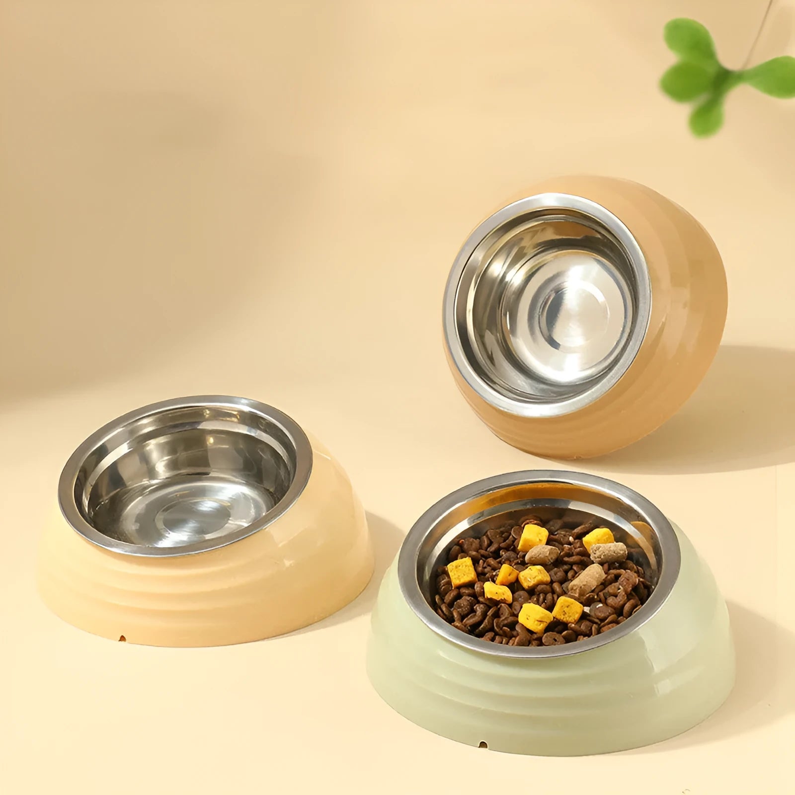 Stainless steel cat bowl on a plastic base in beige, brown, or light green.