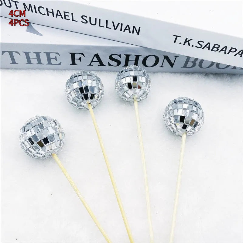 Glass disco ball cake decoration on a wooden stick, shown in different sizes for cake topping.