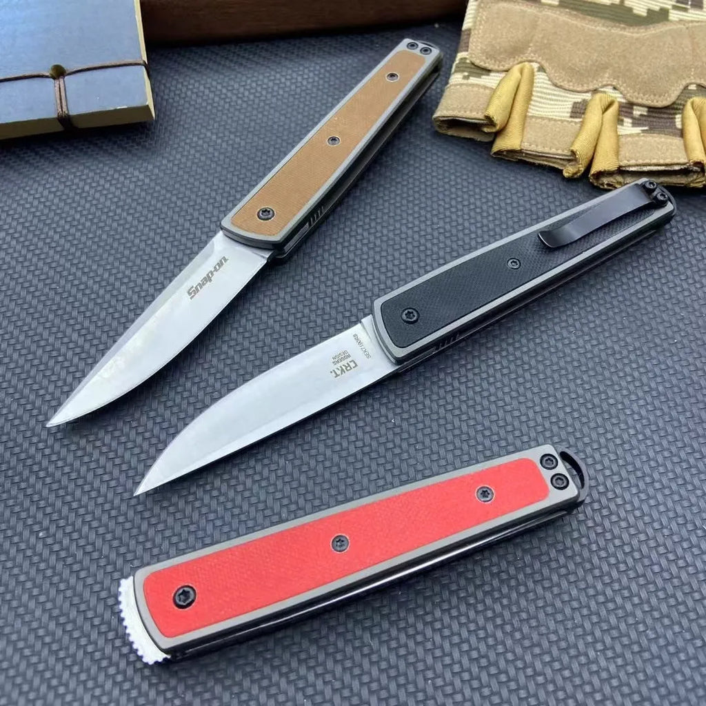 Closed and open views of a black folding fruit knife showing blade and handle.