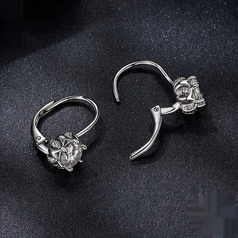 White gold plated sterling silver flower bud ear clip with a moissanite stone.