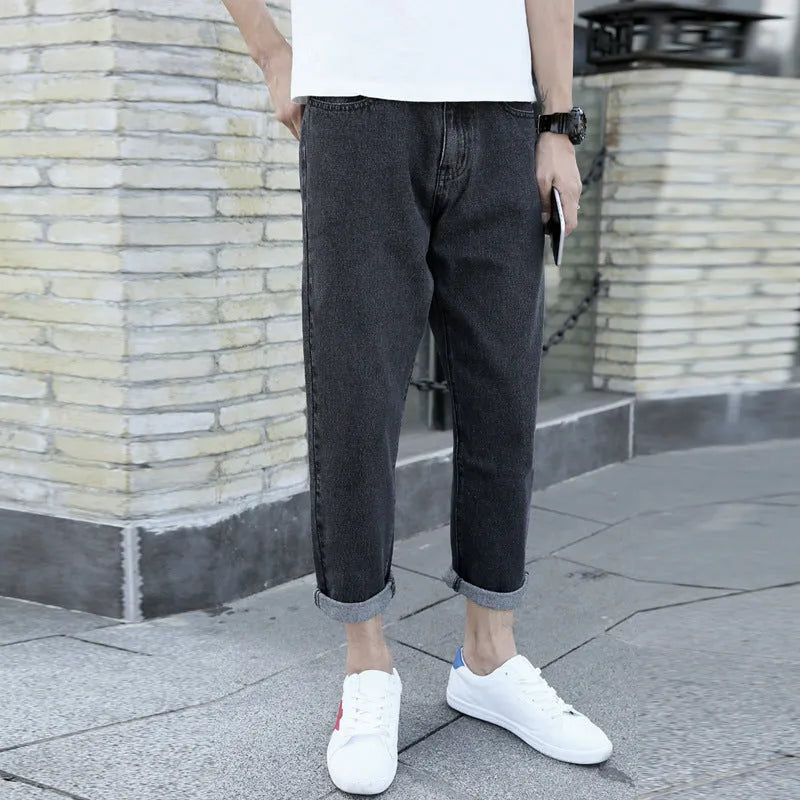 Men's black loose straight-leg jeans with small harem opening on hanger