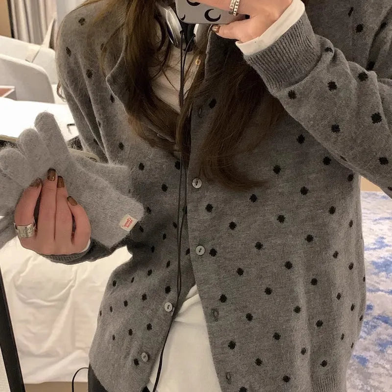 Women's grey dot pattern knitted cardigan with crocheted flower detail and long sleeves