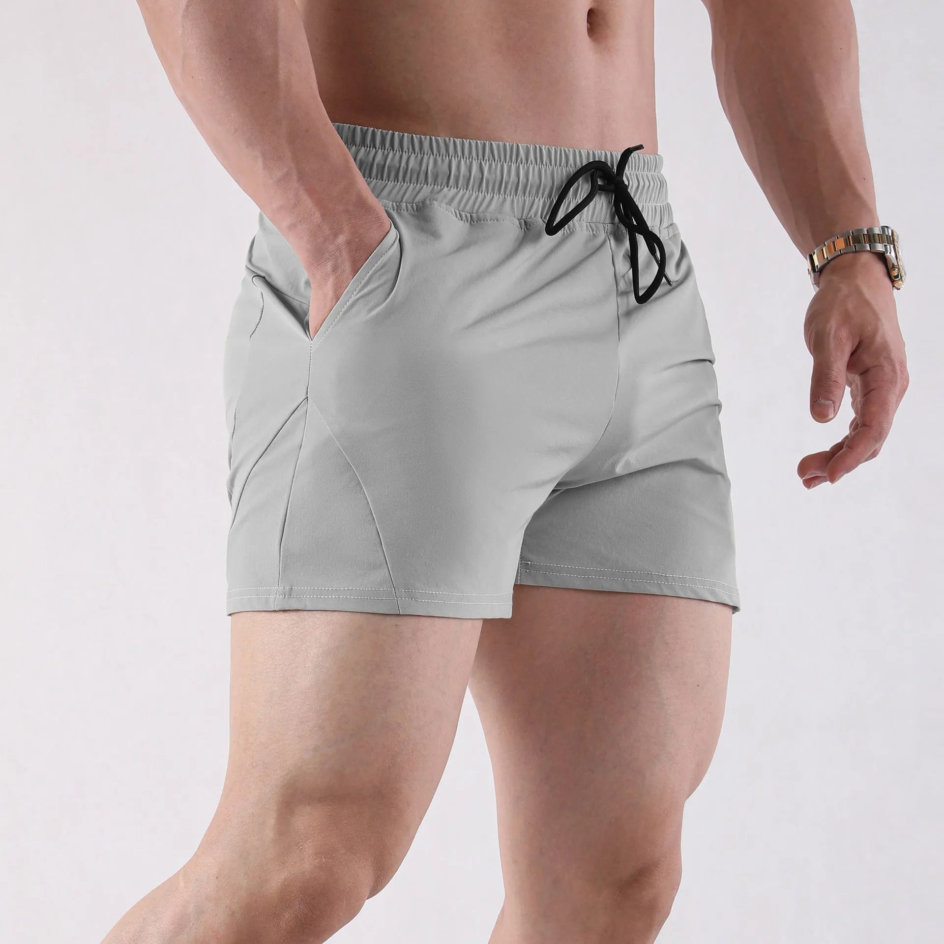 Men's thin grey polyester basketball shorts with an elastic waistband, laid flat.