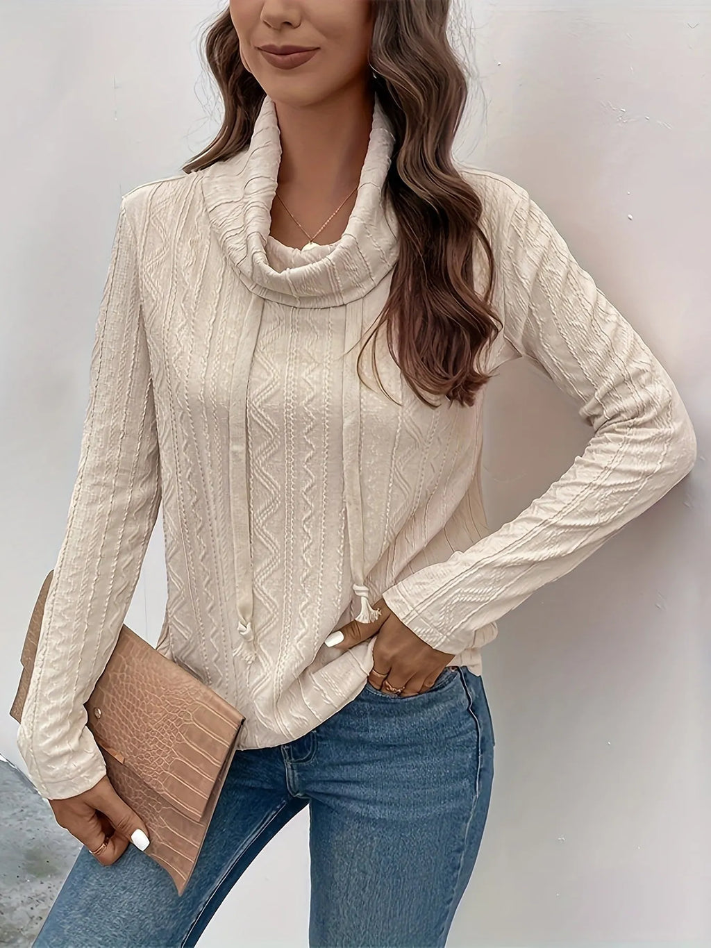 Apricot coloured long sleeve hooded pullover sweater with a drawstring, shown on a hanger.