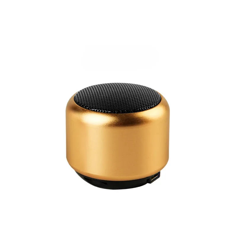 A compact portable Bluetooth mini speaker in black, blue, gold, or pink colour.