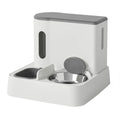 Grey automatic cat feeder and water dispenser station with integrated double bowls on a wooden floor.