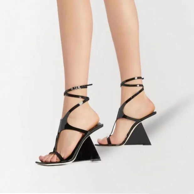 Women's black high heel sandals with square toe and ankle strap button fastening on a white background.