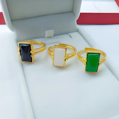 Adjustable brass gold-plated ring with a centre gemstone, shown in black, green, and white colour options.