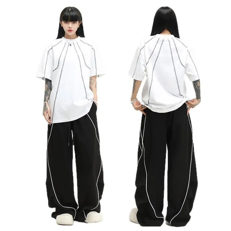 Black pleated hip hop wide-leg pants with stripe pattern showing mid-waist and loose fit