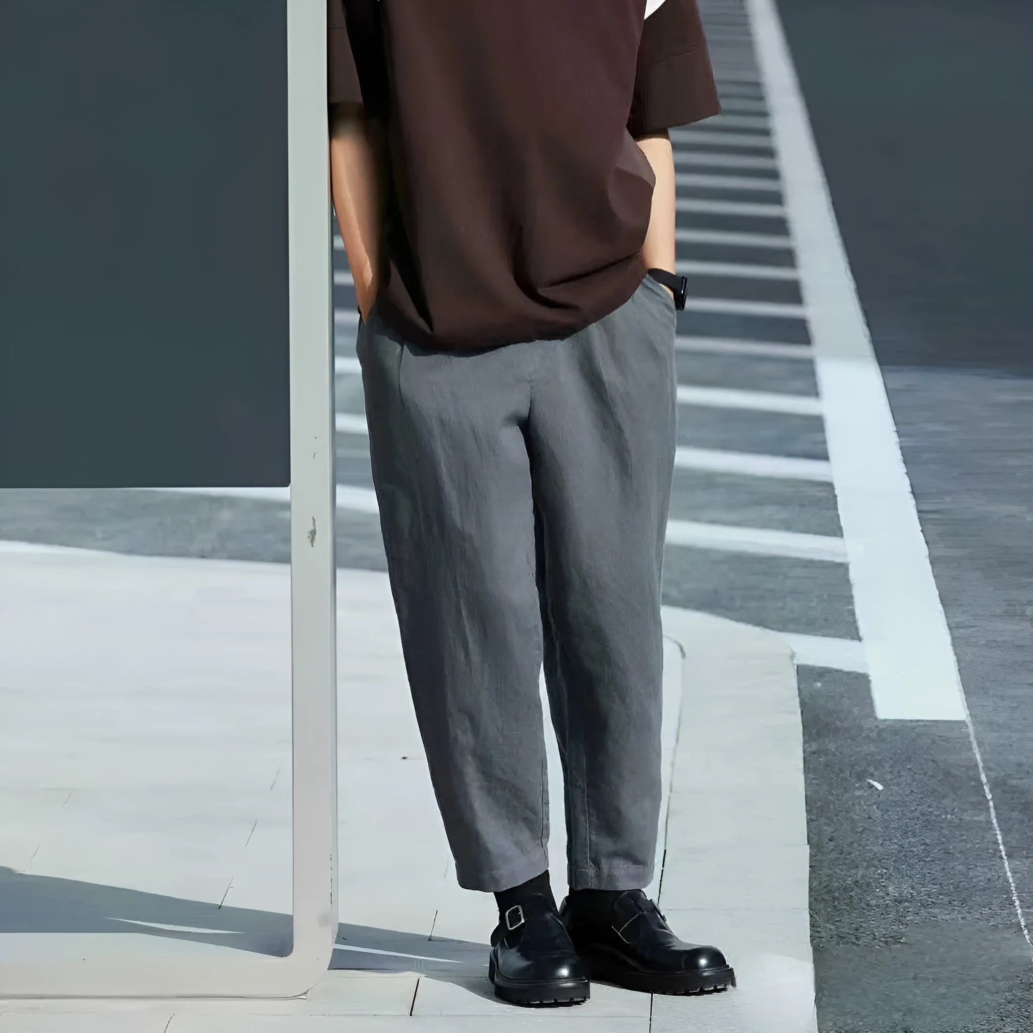Men's beige loose-fit straight-leg casual pants with a drawstring waistband on a hanger.