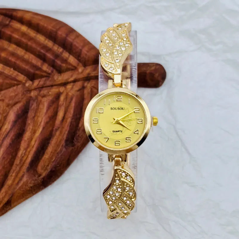 Women's stainless steel fashion watch with round gold dial and vachette clasp.