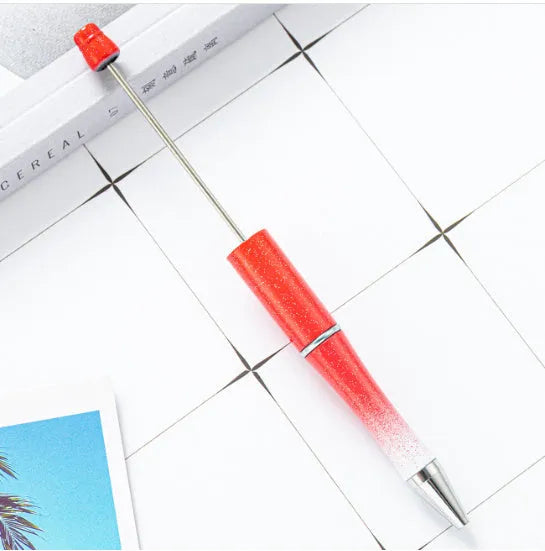 Creative ballpoint pen with multicoloured spinning plastic beads on a steel wire frame.