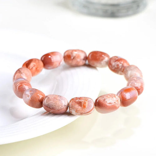 Natural cherry agate barrel bead bracelet with ruyi design elements measuring 10x14mm