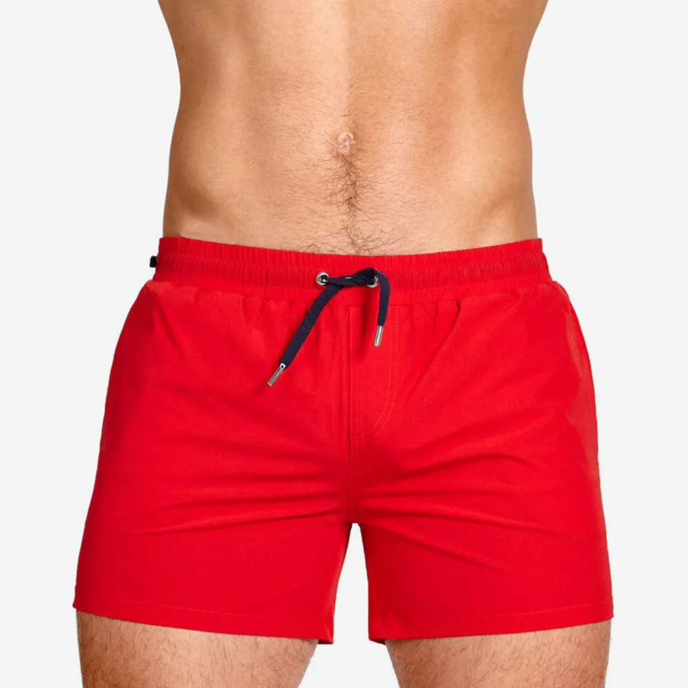 Men's solid colour swimming shorts with mesh lining for sports and fitness activities