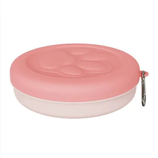 Collapsible silicone dog bowl in light pink and green colours showing portable feeding design