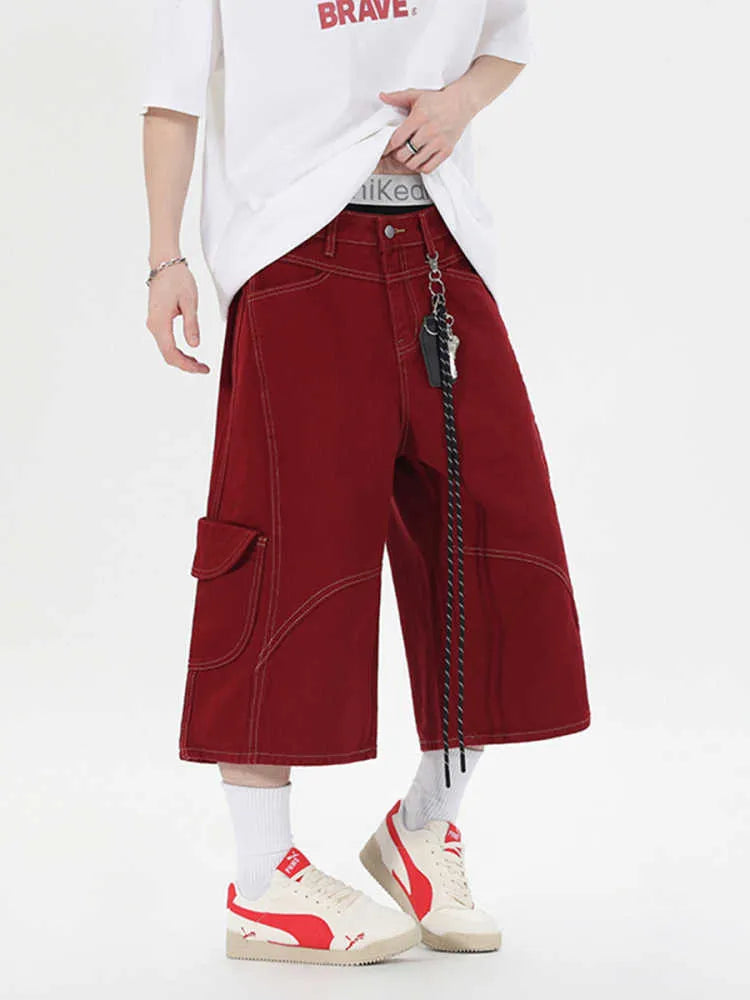 Red retro denim shorts with wide leg and multiple pockets laid flat.