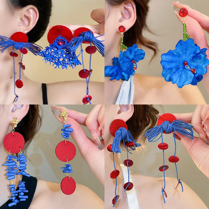 Women's geometric earrings with blue resin flowers on cloth material featuring silver needle elements