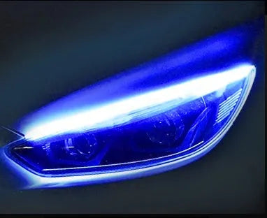 Universal car LED daytime running light strip with flowing turn signal on a vehicle headlight.
