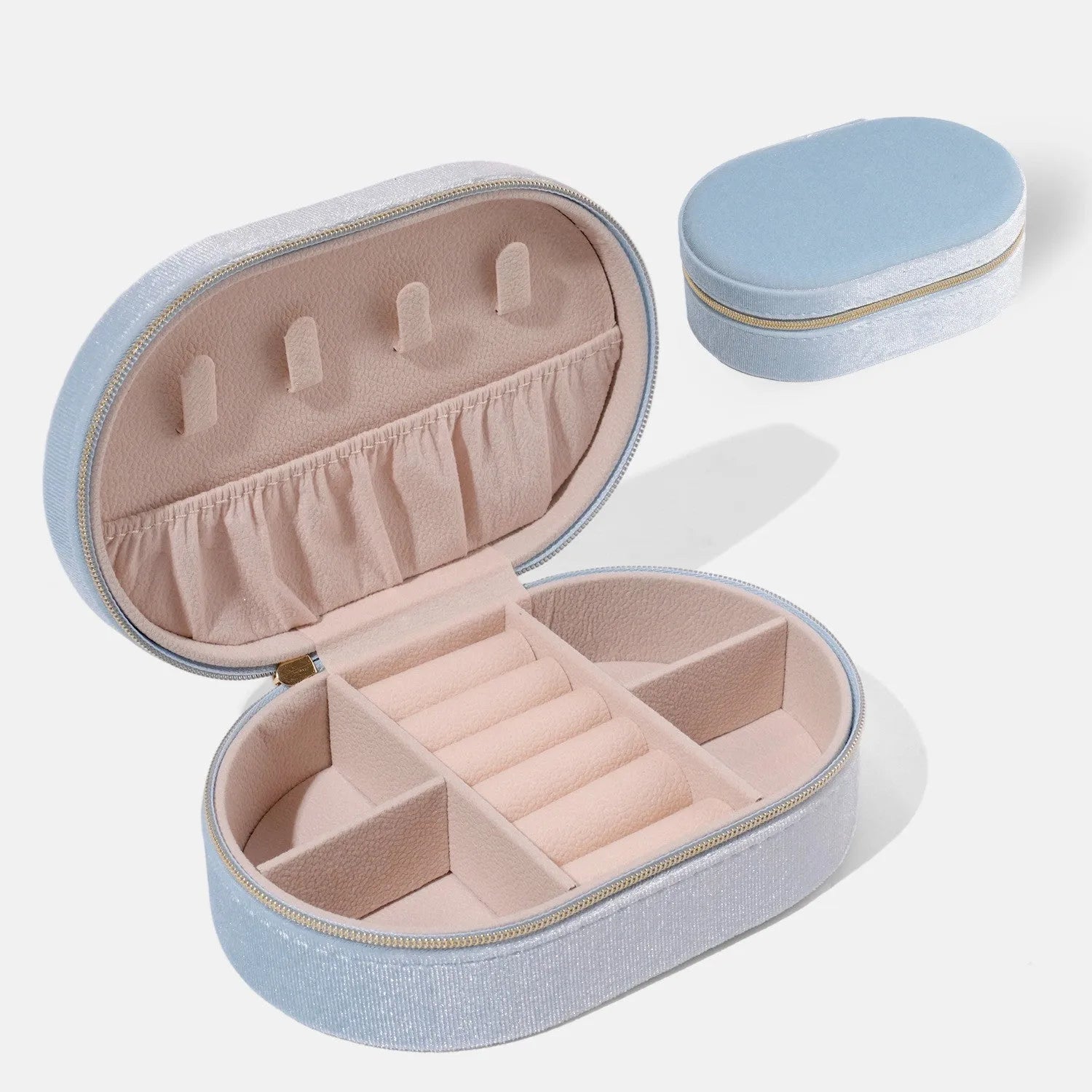 Oval velvet jewellery storage box in lake blue colour with flannel-lined interior compartments
