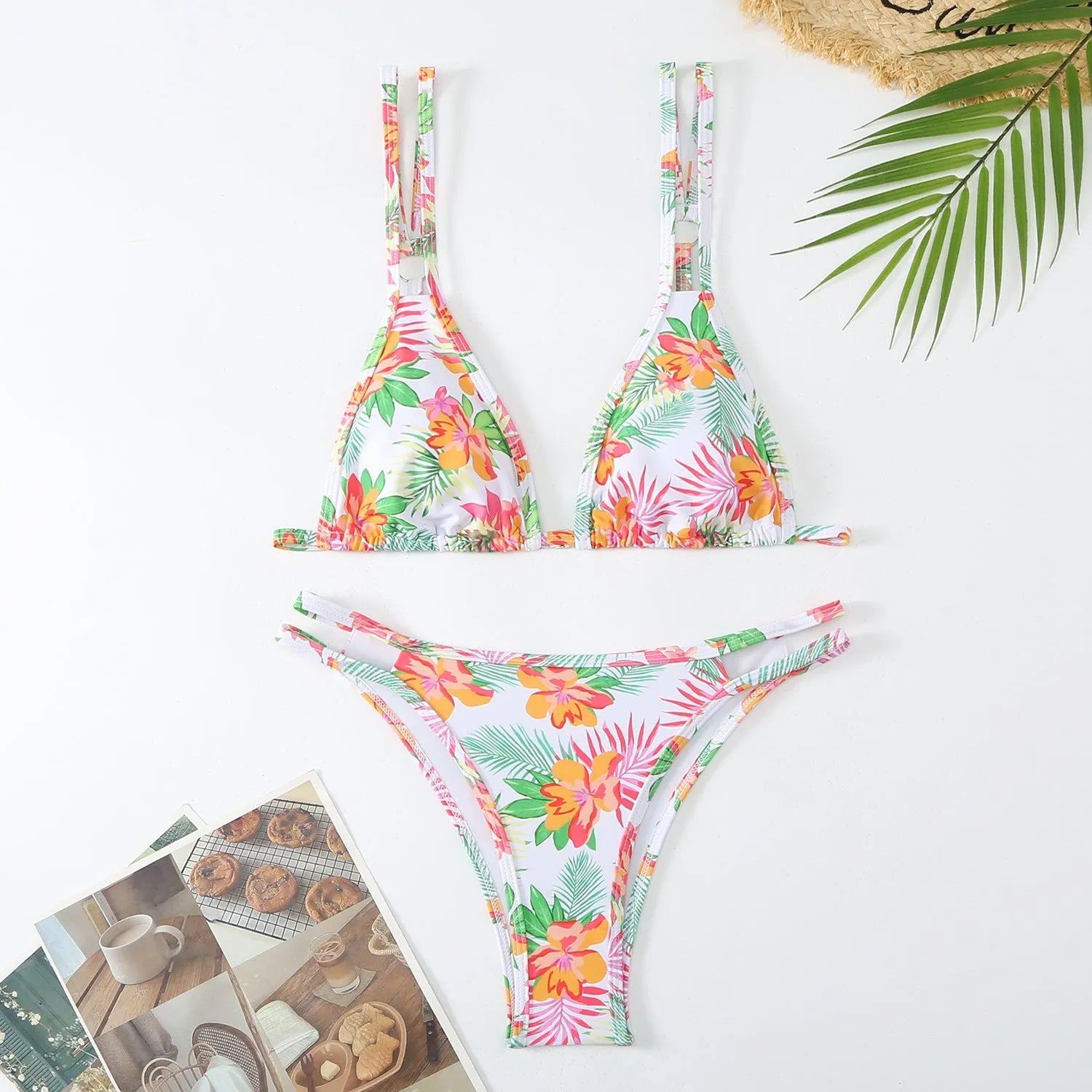 Women's blue halter-style swim briefs with a floral pattern, backless design.