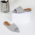 Women's denim flat slippers with tassel detail and leather lining in various colours.