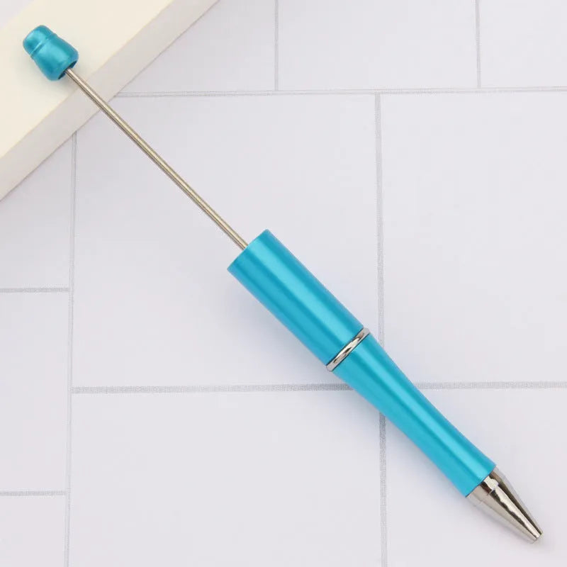 Creative ballpoint pen with multicoloured spinning plastic beads on a steel wire frame.
