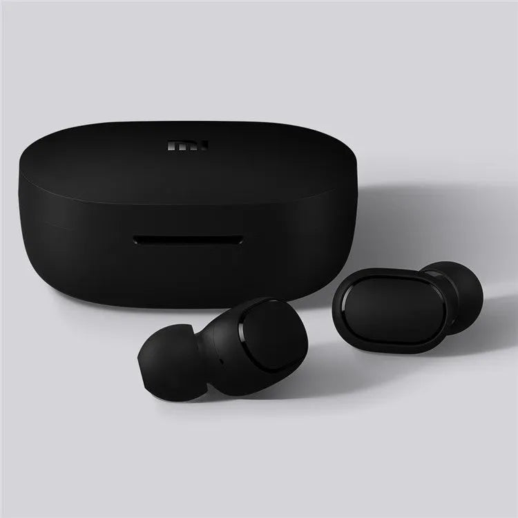 Redmi AirDots Black true wireless earbuds and their white charging case on a table