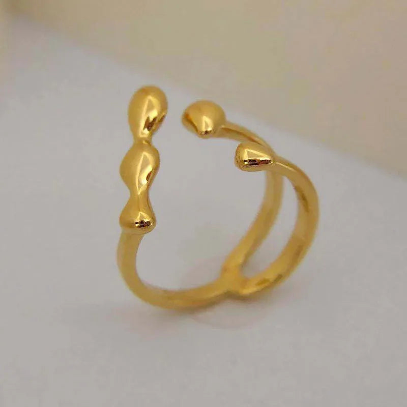 Adjustable brass opening ring with spherical design in gold or silver colour