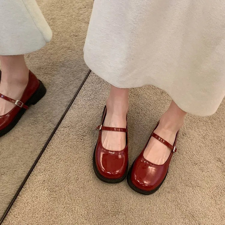 Women's solid colour flat heel loafers in red, black, or greyish black.