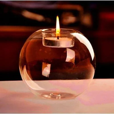 Handmade clear round hollow glass candle holder in three size options on wooden table