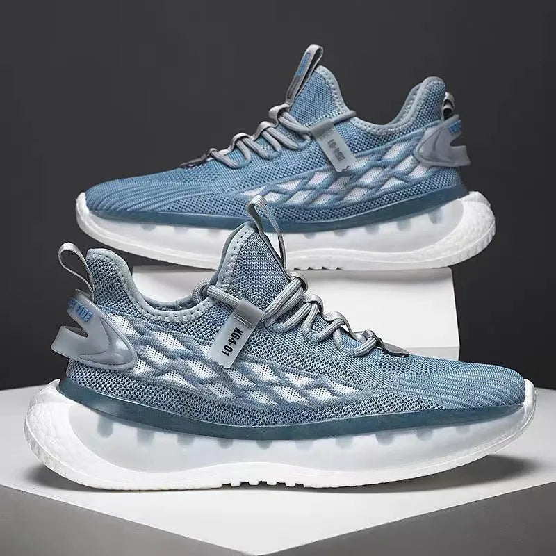 Men's low-top white mesh sneakers with a rubber sole and round toe on a plain background.
