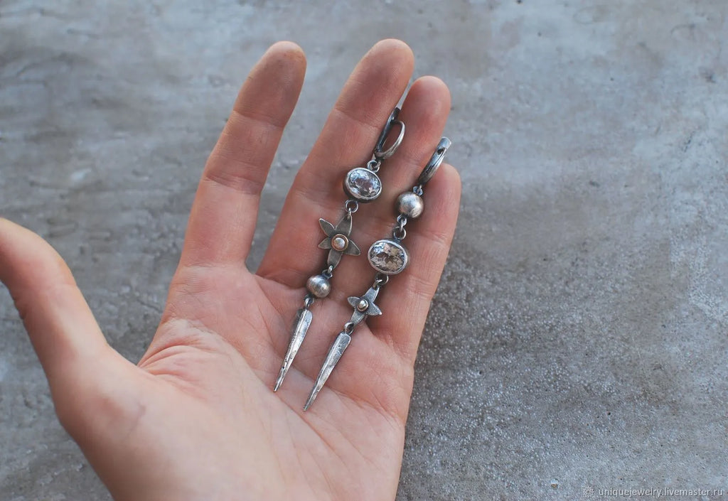 Pair of Hesheng geometric long drop earrings with antique silver XINGX pendant and rhinestones.
