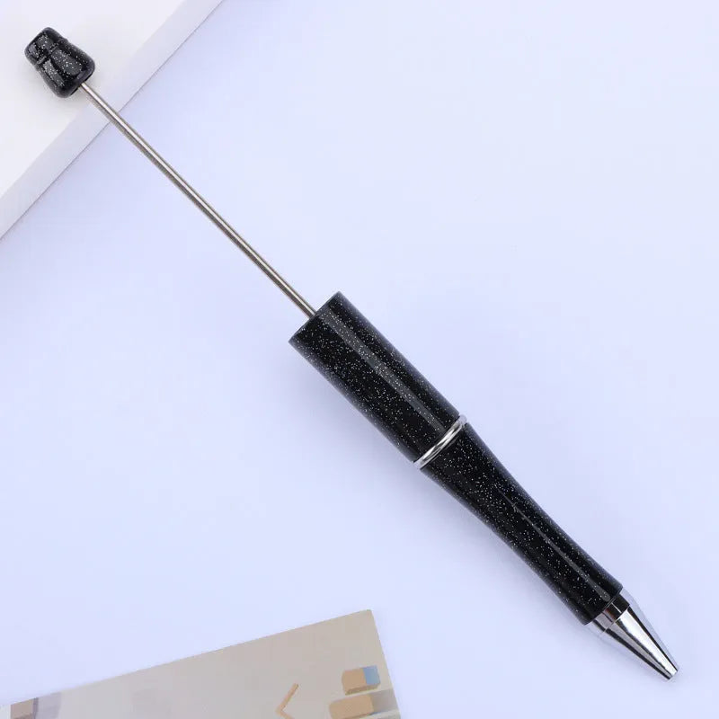 Creative ballpoint pen with multicoloured spinning plastic beads on a steel wire frame.