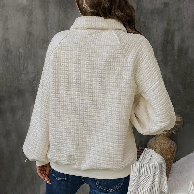Women's milky white sweater with a polo collar and long sleeves laid flat.