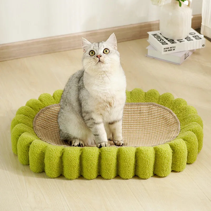 Green oval sisal cat scratching pad serving as a lounging bed, dimensions 650mm by 420mm.