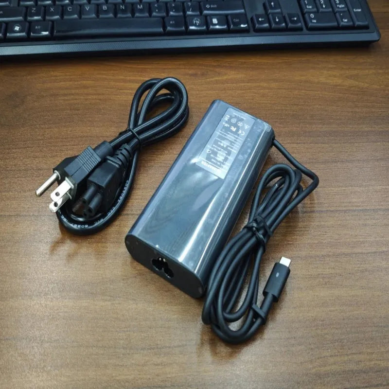 Black 65W Type-C laptop power adapter with multiple international power cords