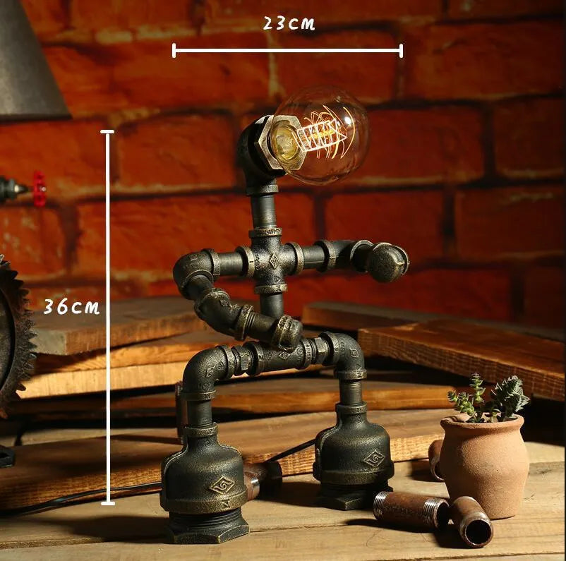 Green bronze vintage industrial robot desk lamp with iron pipe design on a wooden table.