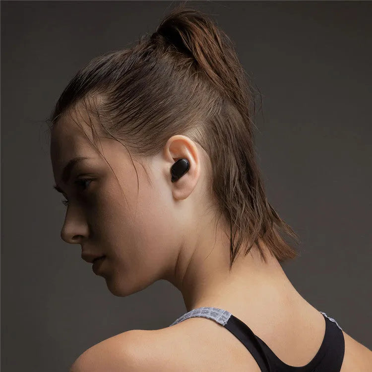 Redmi AirDots Black true wireless earbuds and their white charging case on a table