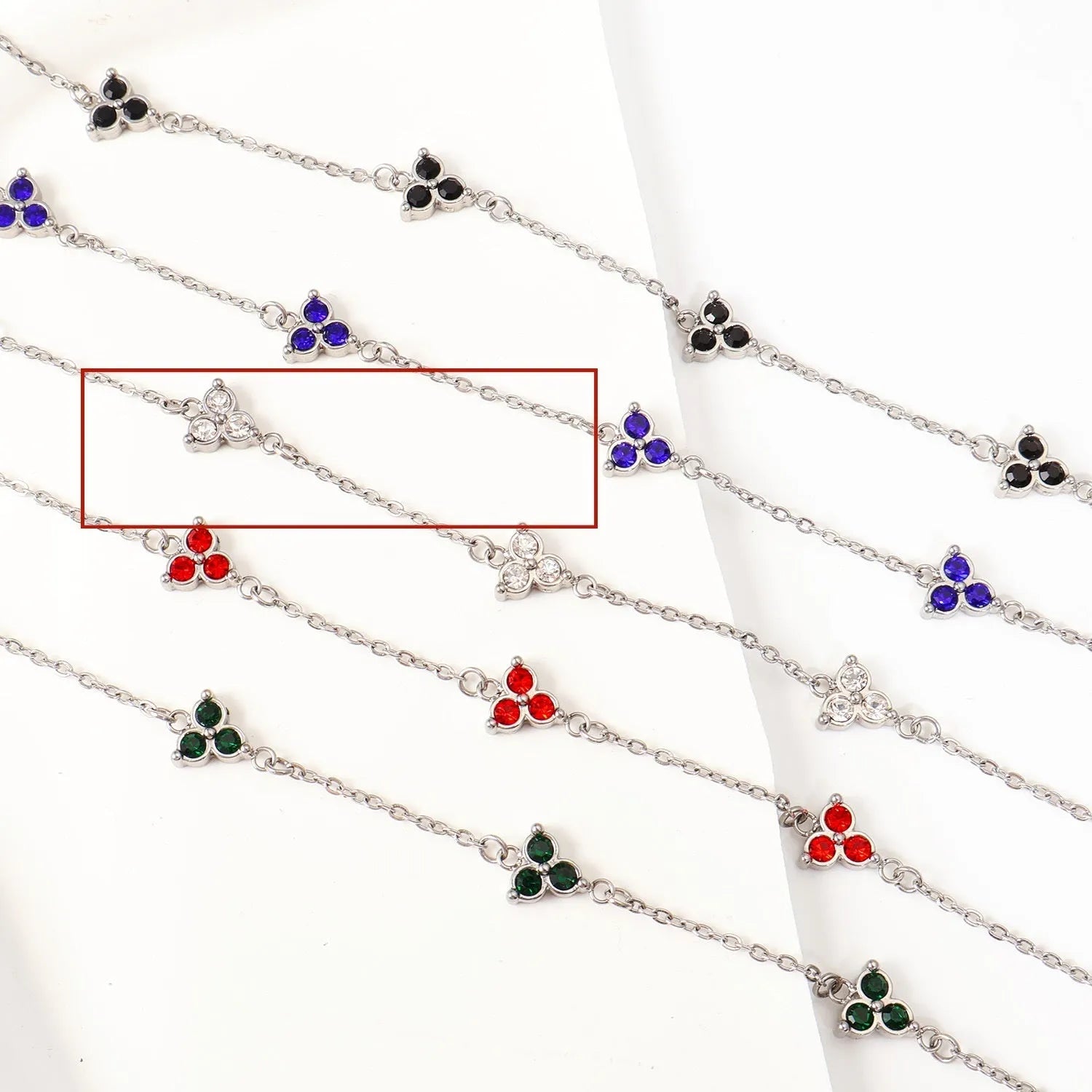 Women's stainless steel geometric triangle bracelet with a three-diamond pattern, shown in a gold and white zircon colour option.