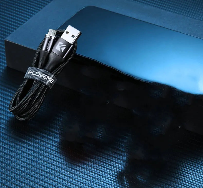 A black magnetic fast-charge data cable with LED light on the connector, next to a smartphone.