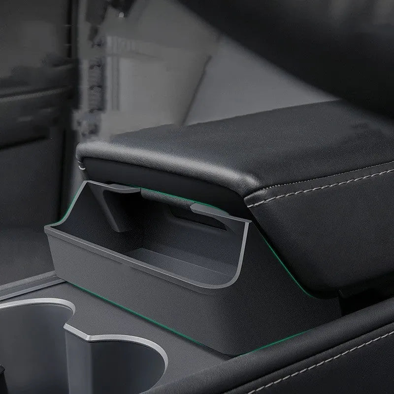 Black silicone sunglasses holder mounted on Tesla Model 3 centre console armrest