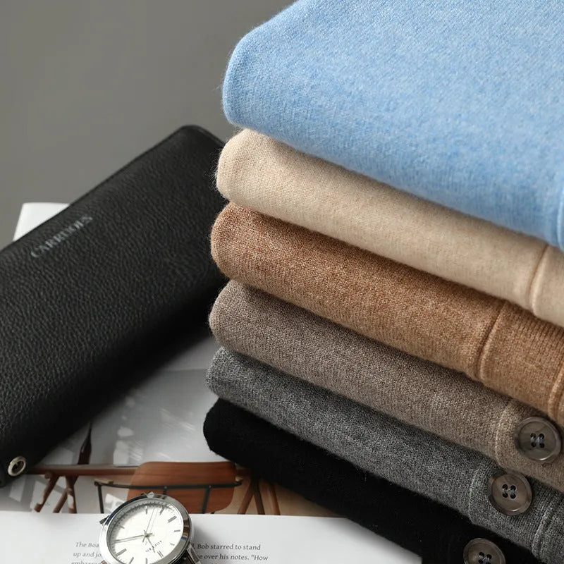 Man wearing a beige V-neck Andy velvet knitted cardigan coat with long sleeves and a loose fit.