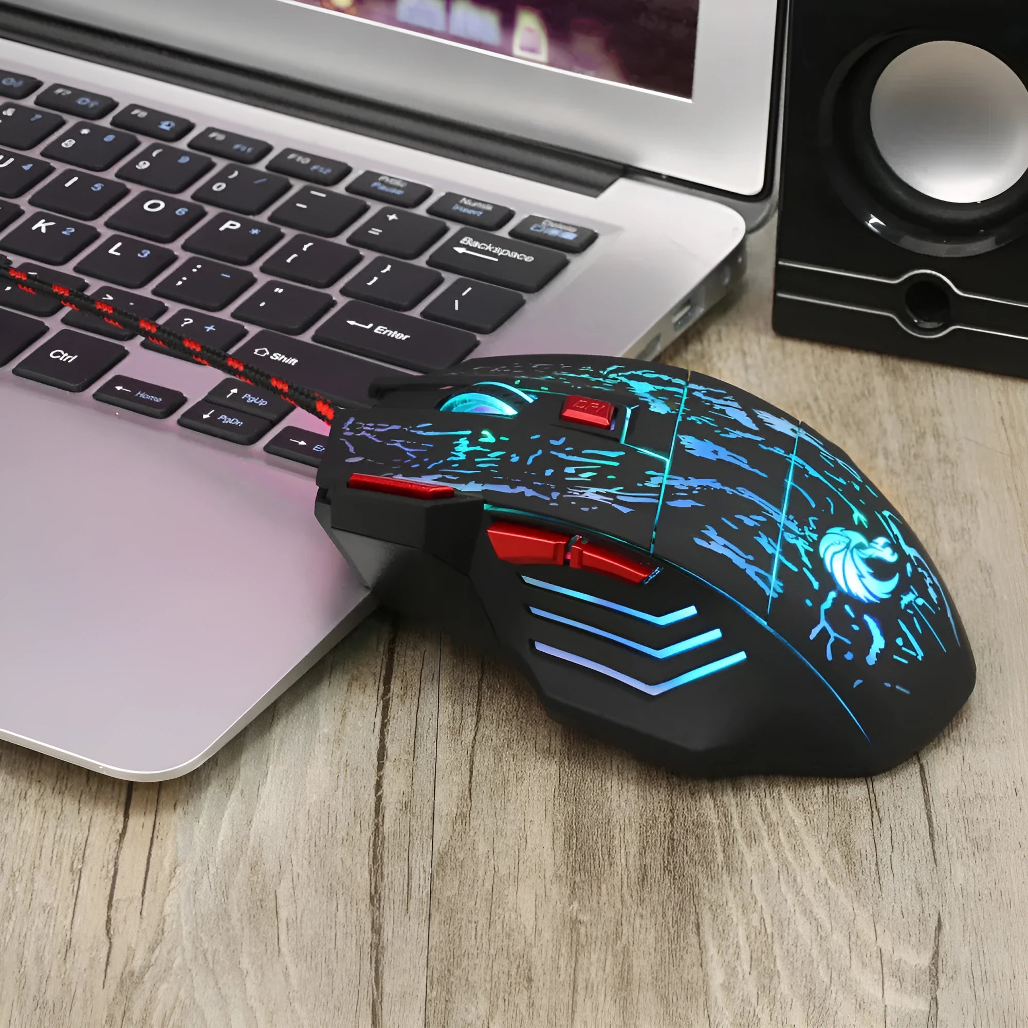 Water Crack colourful luminous wired gaming mouse with USB cable on desktop