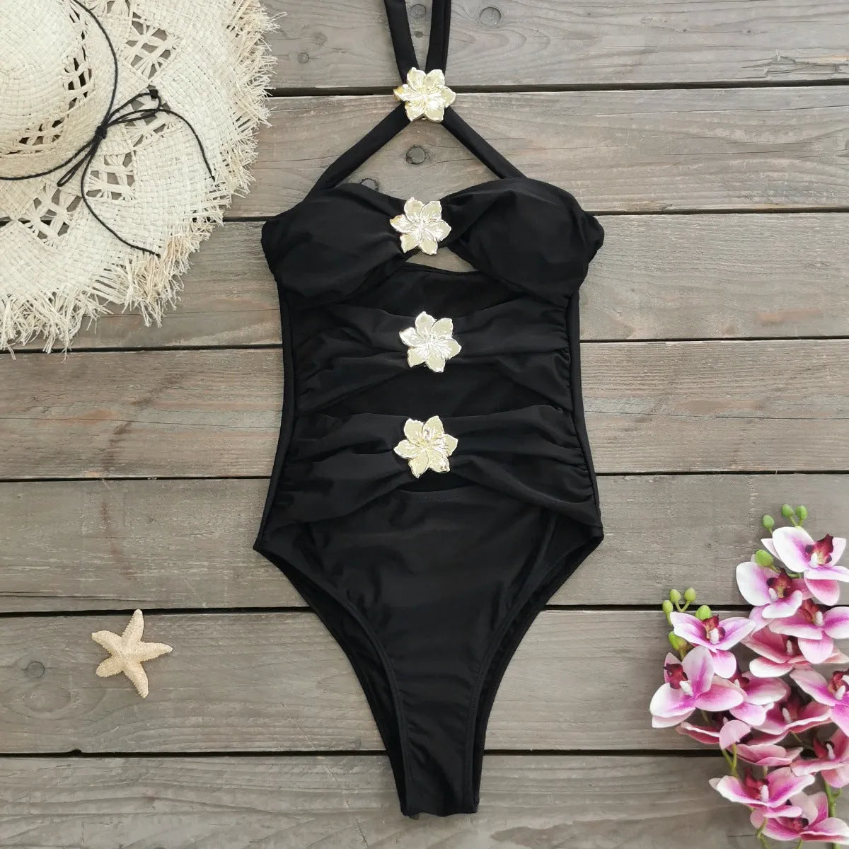 Women's black one-piece swimsuit with matching skirt and hollow-out tube top design
