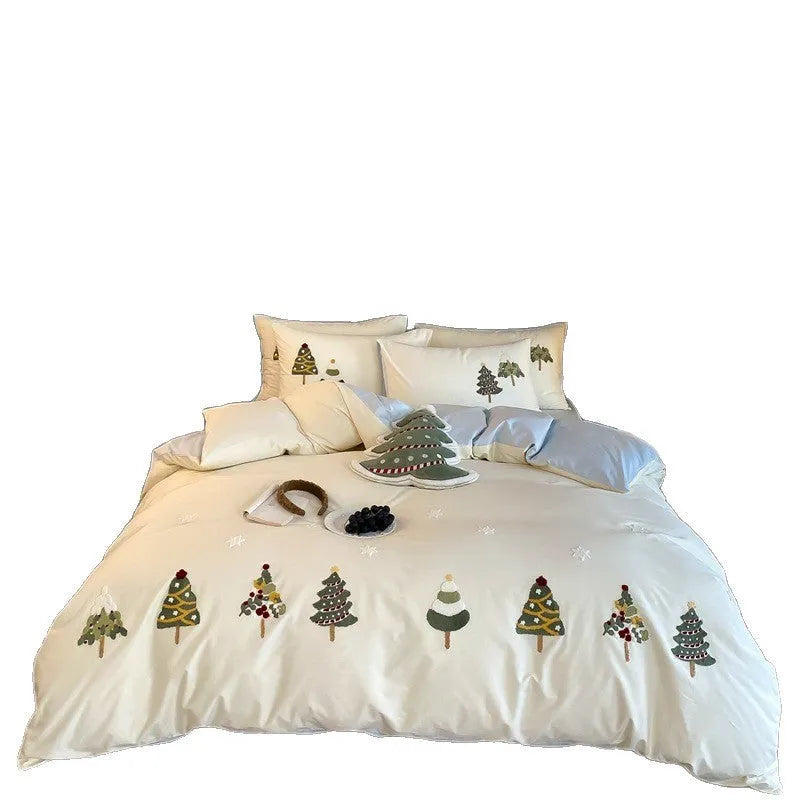 Cream blue Christmas tree embroidered pure cotton duvet cover, flat sheet, and pillowcases on a bed.